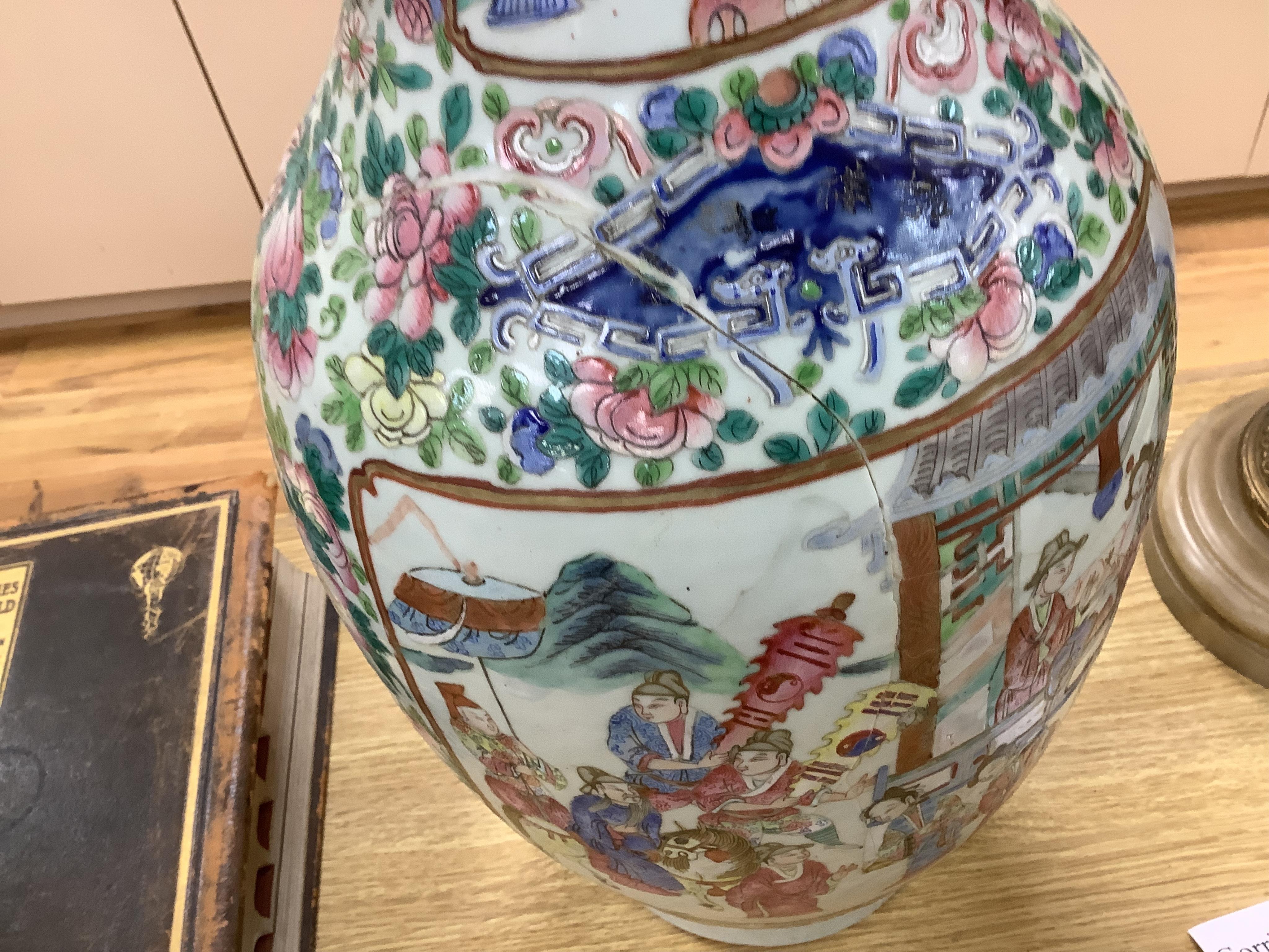 A large Chinese famille rose vase enamelled with figures and flowers, 59cm high (damaged and repaired)